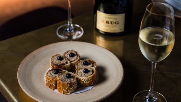 Krug champagne paired with suckling pig sausage rolls at Bennelong in Sydney.