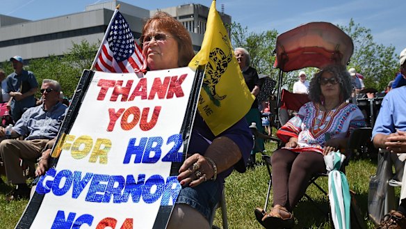 Lee Churchill, of Raleigh, shows her support of the bill during a rally at the Halifax Mall in Raleigh on Monday.