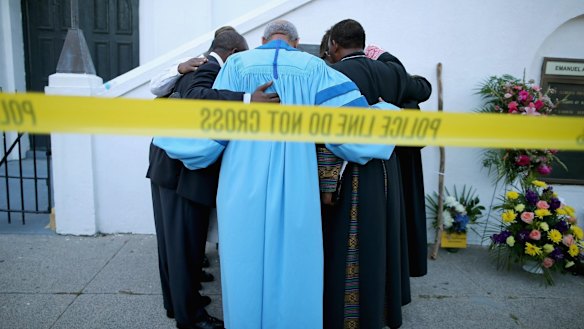 Reverend Sidney Davis and other  pastors pray together outside the historic Emanuel African Methodist Episcopal Church on Thursday. 