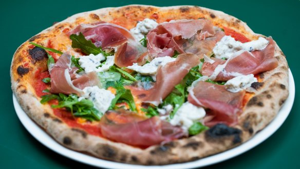 Downtown pizza with tomato, fior di latte, prosciutto, truffled stracciatella and rocket.