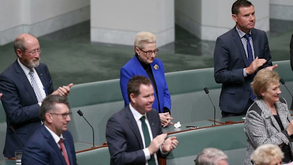 Former speaker Bronwyn Bishop holds her hands as other MPs applaud the election of Tony Smith as her replacement on Monday.