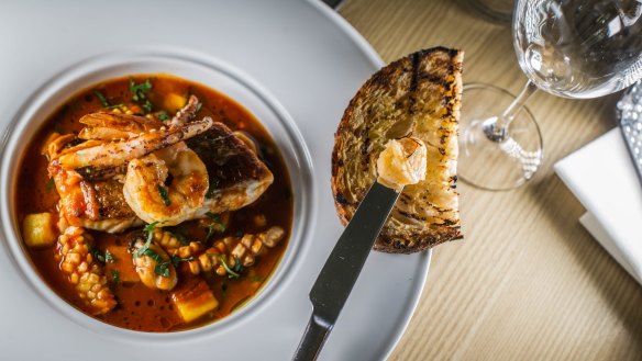 Bouillabaisse is hot, red, minimal in actual soup, and plentiful in the pile of grilled seafood with oiled toast.