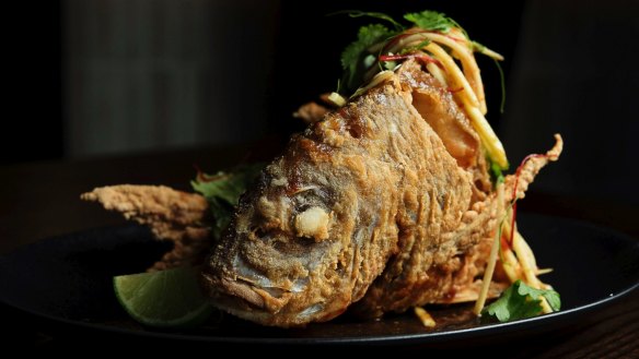 Free-standing whole deep-fried fish with green mango and sweet chilli.