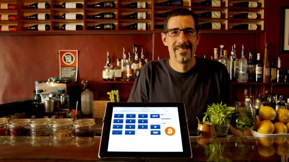 Amir Halpert, the owner of The Owl House in Darlinghurst, shows the bar's bitcoin pay system on his iPad.
