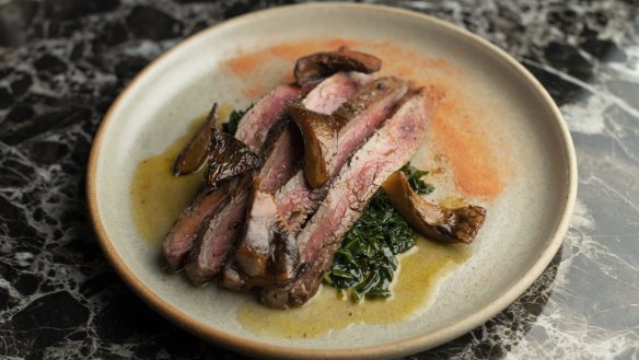 Wagyu flank from Jack's Creek is made autumnal with pan-roasted pine mushrooms and braised kale.