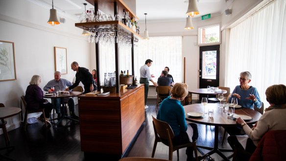 Sixpenny's dining room features a central wooden waiters' station.