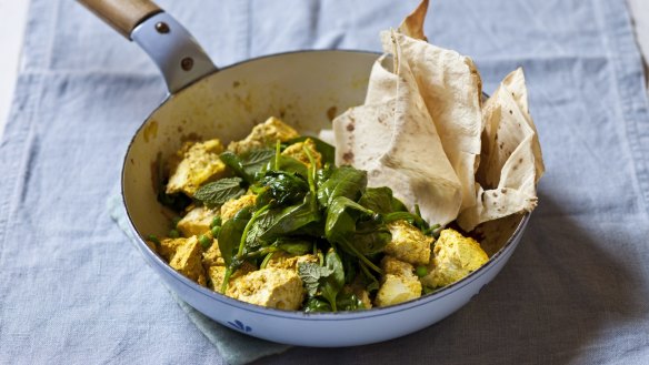 Scrambled curried tofu with spinach and peas.