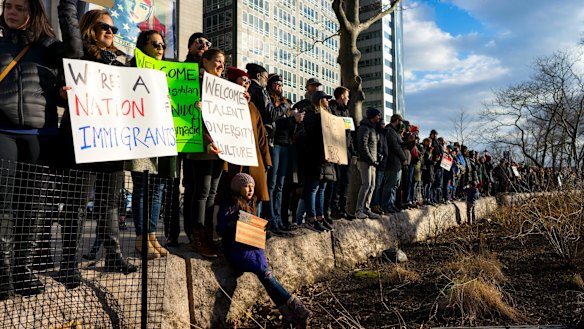 People gather for a rally in New York's Battery Park in New York.
