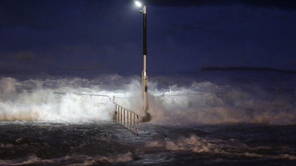 Huge waves crash over swimming baths at Avalon Beach. 