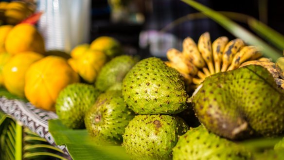 Soursop (foreground), bananas and papaya at Punanga Nui Market, Aitutaki, Cook Islands.