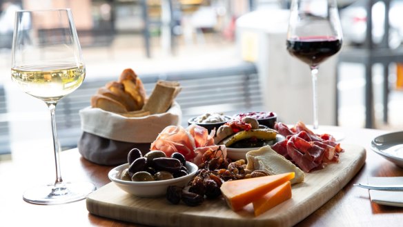 The grazing platter with cheeses, meats, dips, antipasto, nuts and wine.
