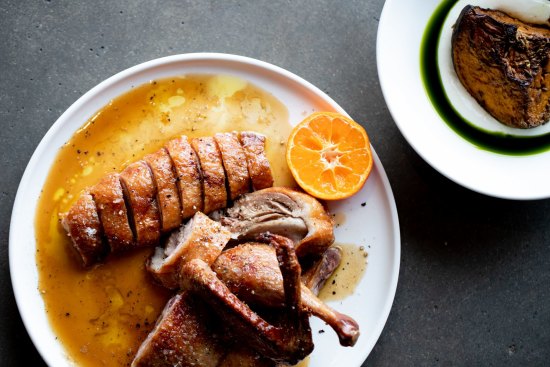 Wood-roasted half duck with burnt butter and mandarin is the go-to dish (roast pumpkin with coriander oil also pictured, top right).