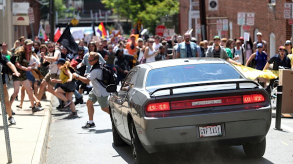 A vehicle drives into a group of protesters demonstrating against a white nationalist rally in Charlottesville.
