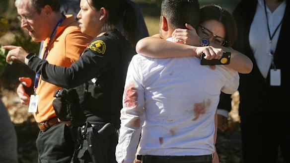 A couple embraces following the shooting.