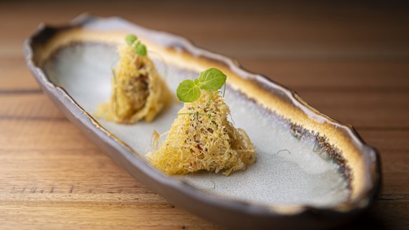 Peppered shallots, corn-fed chicken, lemongrass and coriander in eggnet parcels. 