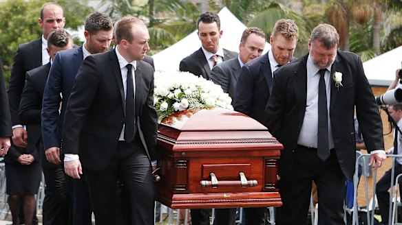 Final farewell: Brother Jason, left, and father Greg, right, carry Phillip Hughes' coffin during the funeral service.