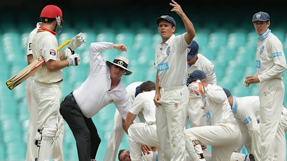 Umpires and players call for help as Hughes hit the ground. 