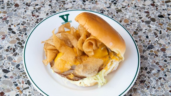 Fried mortadella sandwich with crisp luncheon meat, gooey cheese, iceberg lettuce and crispy potato chips.