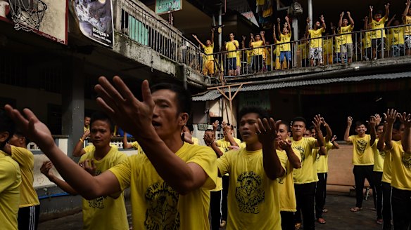 Prisoners sing and dance during an exercise routine at Quezon city jail.