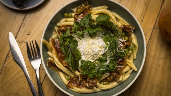 Small Axe's signature breakfast pasta: maccaruni with guanciale, peas, mint, salted ricotta and a slow-cooked egg.