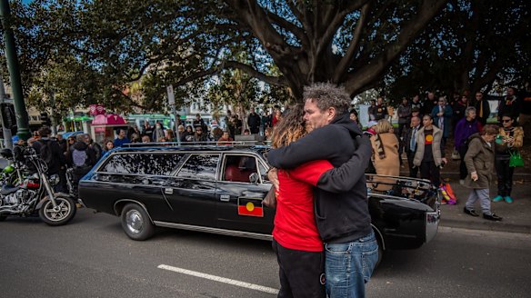 Mourners watch the hearse pass Cleve Gardens in St Kilda.
