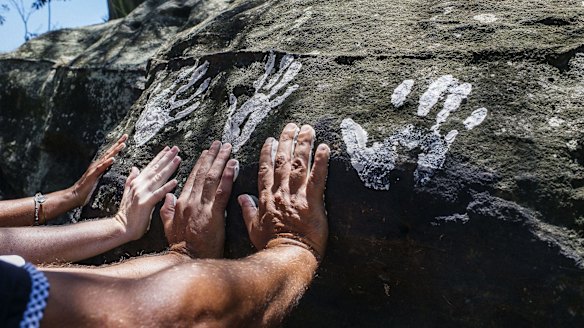 Hand prints are placed at Goat Island by local Aboriginal children.