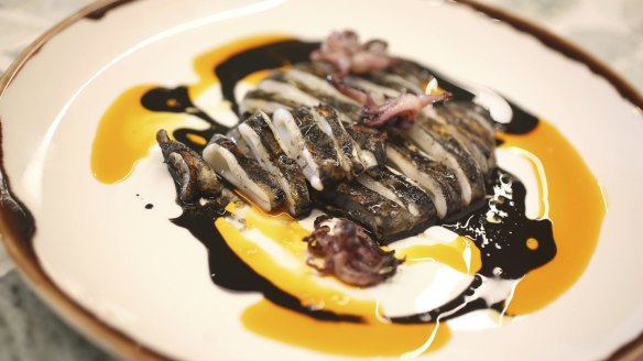 Calamari over the coals served with its own inky black sauce.