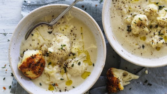 Creamy cauliflower cheese soup pictured with pieces of parmesan and thyme monkey bread (see recipe below).