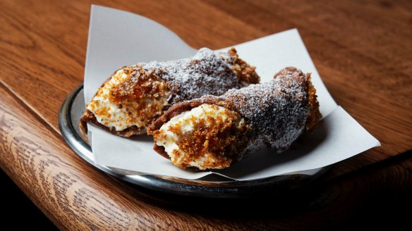 Filled-to-order cannoli with whipped buttermilk ricotta and orange and pistachio praline.