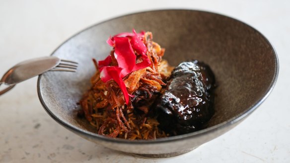 Lamb collar, carob molasses, mujaddara, rose petals. 