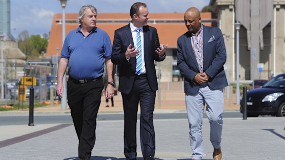 Signed up: Chief Minister Andrew Barr talks with future Uber drivers Gary Woodbridge and Teferi Gungl.
