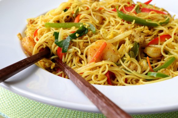 Curry powder gives Singapore noodles its signature golden colour.