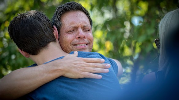Don Damond was comforted by friends after his fiancee, Justine Damond, was shot by police.