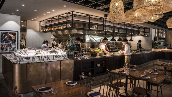 Chef Jay Lao works the charcoal grill in Ruse's very open kitchen.