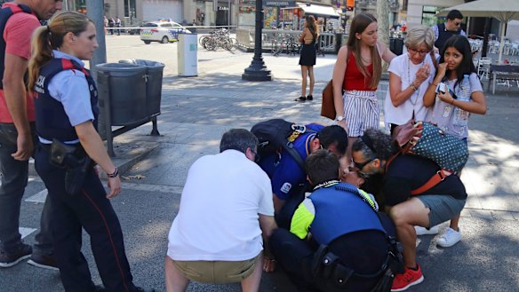 A person is treated in the Las Ramblas district on Thursday.