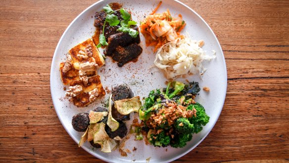 Build your own tasting plate, perhaps (pictured clockwise from top left) Korean-style beef short rib, pickles, miso greens, house-made black pudding with apple, and haloumi with walnuts and honey.