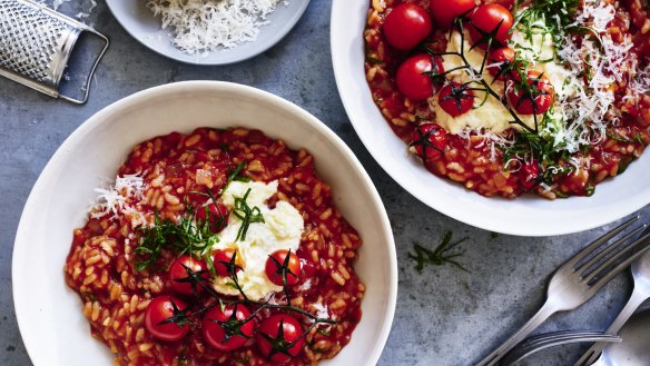 Tomato risotto finished with stracciatella and parmigiano cheeses.