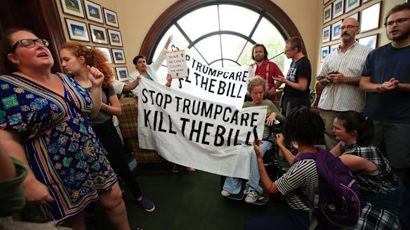 Protesters  gather inside the office of Republican Ohio senator Rob Portman on Monday.