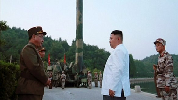 North Korean leader Kim Jong-un and a missile launcher in North Korea.