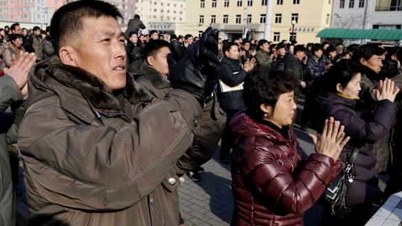 North Koreans watch the nuclear test news broadcast on a video screen outside Pyongyang Railway Station in North Korea on Wednesday.