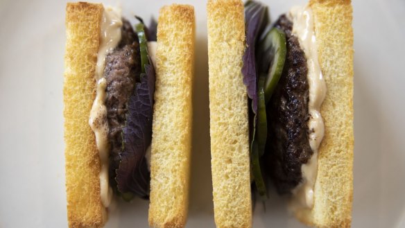 Crustless brioche finger sandwiches filled with dry-aged beef, soy sauce mayonnaise and pickled cucumber.