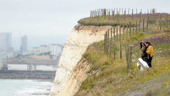 People lay flowers at the clifftop where Arthur Cave fell to his death.