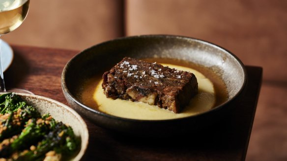 Pressed lamb shoulder with a golden pond of soft, loose polenta.