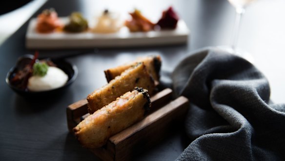 Prawn toasts are cutely served in wooden toast racks.