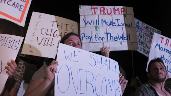 Demonstrators hold posters during a protest against US President Donald Trump next to the American consulate on in Jerusalem on Monday.