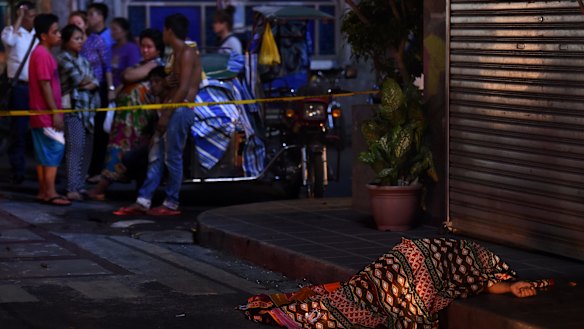 One of two people killed in a double shooting in the Manila suburb of Baclaran is left lying in the street. 