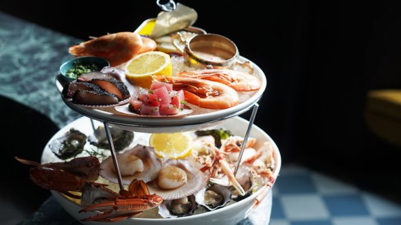 The towering seafood platter with crab legs akimbo.