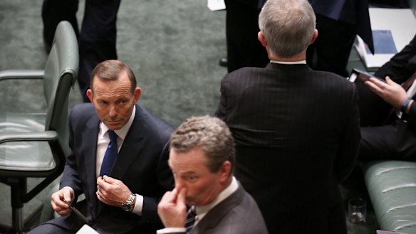 Malcolm Turnbull passes Prime Minister Tony Abbott and Christopher Pyne on Wednesday.