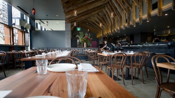 The restaurant has repurposed wooden beams from Bega Flats for the ceiling and tables. 