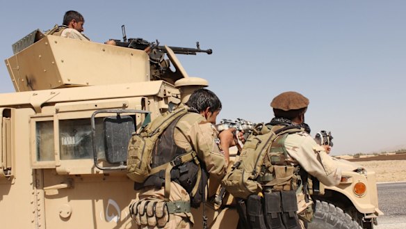 Afghanistani security forces take their position during a clash with Taliban fighters in the highway between Balkh province to Kunduz city on Thursday.